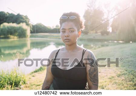 Young woman by lake View Large Photo Image Stock Image - Young woman by lake. Fotosearch