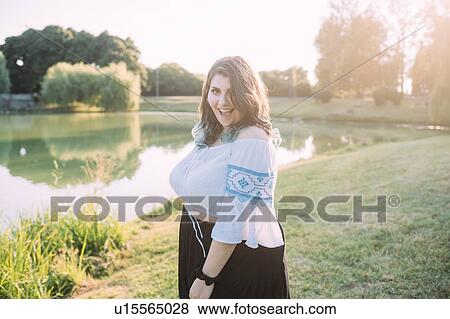 Stock Photo - Young woman by lake. Fotosearch