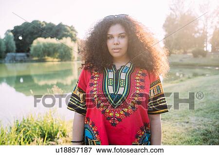 Young woman by lake View Large Photo Image Stock Photo - Young woman by lake. Fotosearch