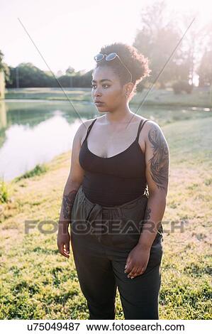 Young woman by lake View Large Photo Image Stock Photo - Young woman by lake. Fotosearch