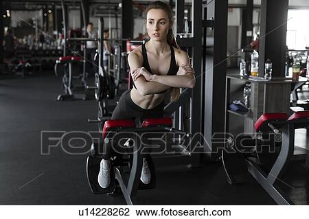 Young woman doing reverse sit-ups in gym View Large Photo Image Stock Image - Young woman doing reverse sit-ups in gym. Fotosearch
