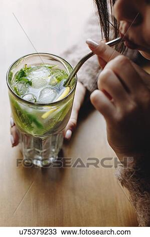 Young woman drinking cocktail View Large Photo Image Stock Image - Young woman drinking cocktail. Fotosearch