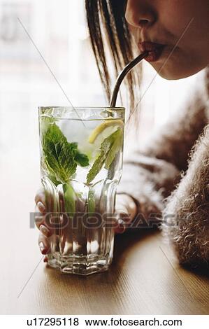 Young woman drinking cocktail View Large Photo Image Stock Photo - Young woman drinking cocktail. Fotosearch