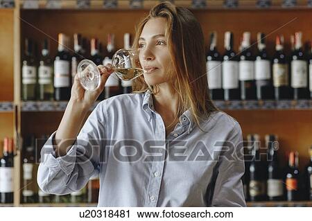 Young woman drinking glass of white wine View Large Photo Image Stock Image - Young woman drinking glass of white wine. Fotosearch