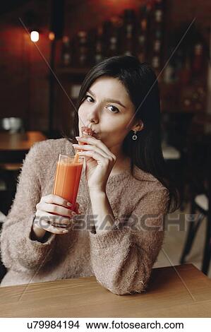 Young woman drinking juice View Large Photo Image Picture - Young woman drinking juice. Fotosearch