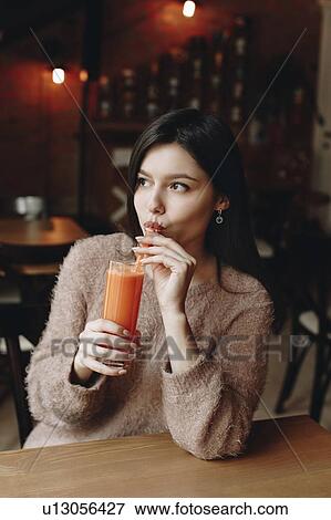 Young woman drinking juice View Large Photo Image Stock Photo - Young woman drinking juice. Fotosearch