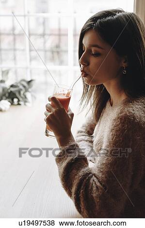Young woman drinking juice View Large Photo Image Stock Photo - Young woman drinking juice. Fotosearch