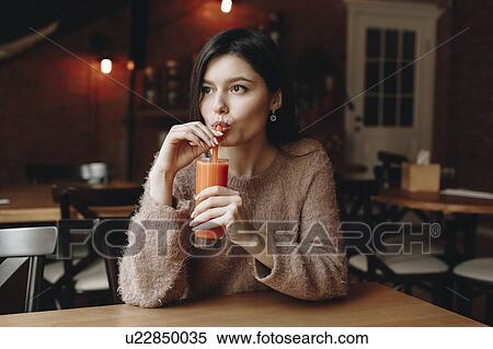 Young woman drinking juice View Large Photo Image Stock Photography - Young woman drinking juice. Fotosearch