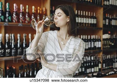 Young woman drinking white wine View Large Photo Image Stock Photo - Young woman drinking white wine. Fotosearch