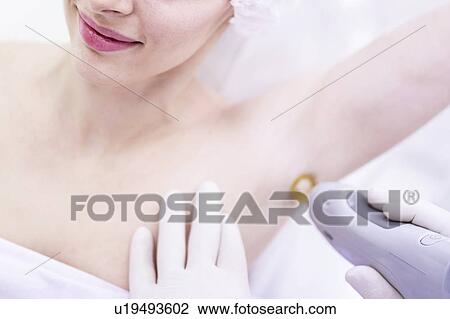 Young woman having laser hair removal treatment under her arm. Laser hair removal permanently destroys the root of the hair follicles by using pulses of light. View Large Photo Image Stock Image - Young woman having laser hair removal treatment under her arm. Laser hair removal permanently destroys the root of the hair follicles by using pulses of light.. Fotosearch