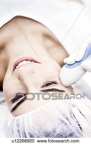 Young woman having laser peeling treatment, close-up. This treatment smooths and rejuvenates the skin. View Large Photo Image Stock Image - Young woman having laser peeling treatment, close-up. This treatment smooths and rejuvenates the skin.. Fotosearch