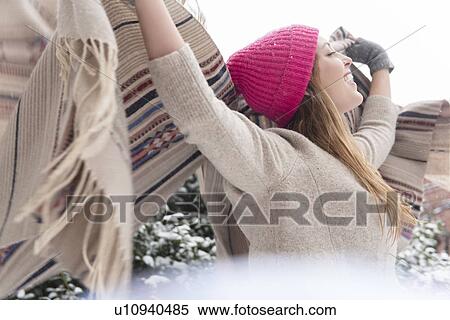 Young woman holding shawl aloft in snow View Large Photo Image Stock Photography - Young woman holding shawl aloft in snow. Fotosearch