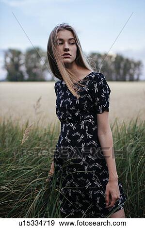 Stock Photo - Young woman in field. Fotosearch