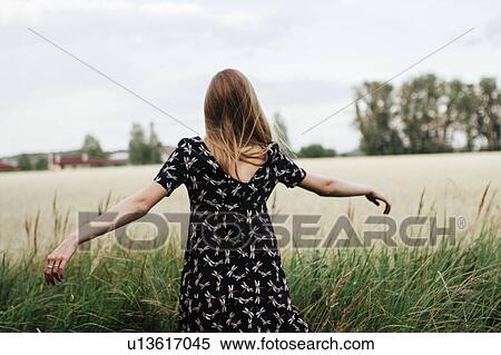 Young woman in field View Large Photo Image Stock Photography - Young woman in field. Fotosearch