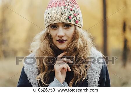 Young woman in floral pattern woolen hat View Large Photo Image Stock Image - Young woman in floral pattern woolen hat. Fotosearch