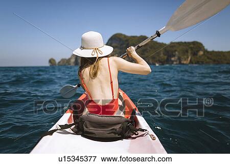 Stock Photo - Young woman in kayak on sea in Krabi, Thailand. Fotosearch