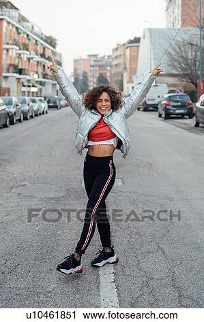 Stock Image - Young woman in middle of street, Milano, Lombardia, Italy. Fotosearch
