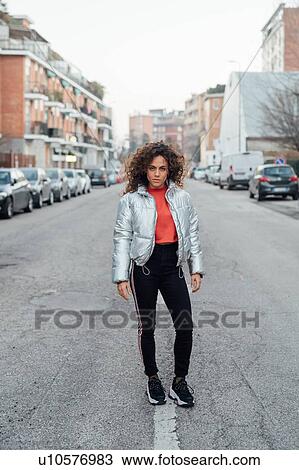 Young woman in middle of street, Milano, Lombardia, Italy View Large Photo Image Stock Image - Young woman in middle of street, Milano, Lombardia, Italy. Fotosearch