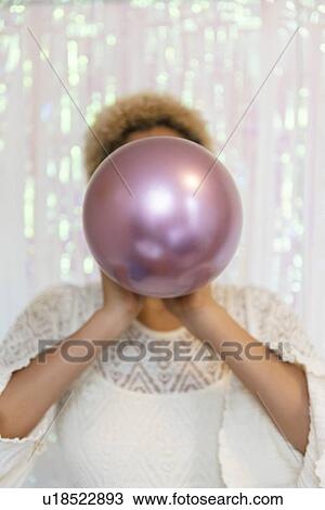 Young woman inflating balloon View Large Photo Image Stock Image - Young woman inflating balloon. Fotosearch