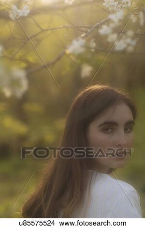 Young woman looking over her shoulder View Large Photo Image Picture - Young woman looking over her shoulder. Fotosearch