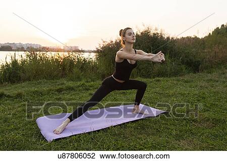 Young woman practicing yoga in park View Large Photo Image Stock Image - Young woman practicing yoga in park. Fotosearch