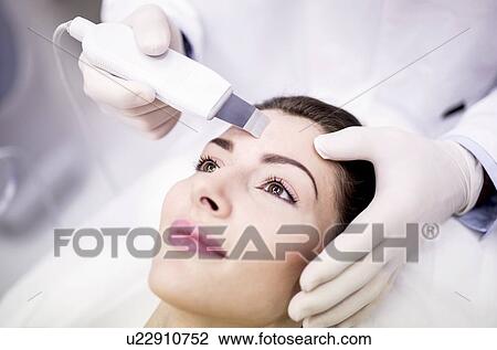 Young woman receiving facial microdermabrasion treatment in clinic, close-up. The cosmetic procedure uses micro crystals to remove dead skin cells. This exfoliating treatment can stimulate the production of collagen and help improve fine lines and... View Large Photo Image Stock Image - Young woman receiving facial microdermabrasion treatment in clinic, close-up. The cosmetic procedure uses micro crystals to remove dead skin cells. This exfoliating treatment can stimulate the production of collagen and help improve fine lines and.... Fotosearch