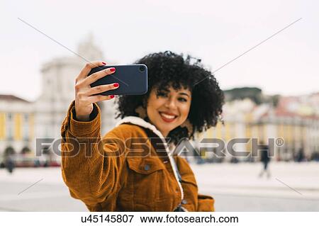 Young woman taking selfie in Lisbon, Portugal View Large Photo Image Stock Photo - Young woman taking selfie in Lisbon, Portugal. Fotosearch