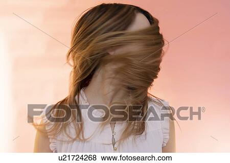 Stock Photo - Young woman tossing her hair. Fotosearch