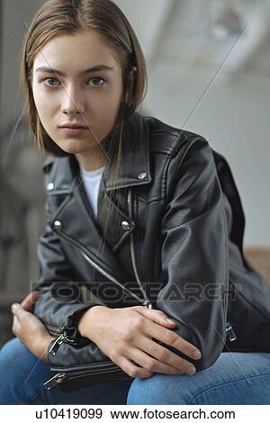 Young woman wearing black leather jacket View Large Photo Image Stock Photo - Young woman wearing black leather jacket. Fotosearch