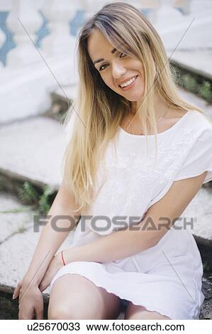 Young woman wearing white dress sitting on steps View Large Photo Image Stock Image - Young woman wearing white dress sitting on steps. Fotosearch