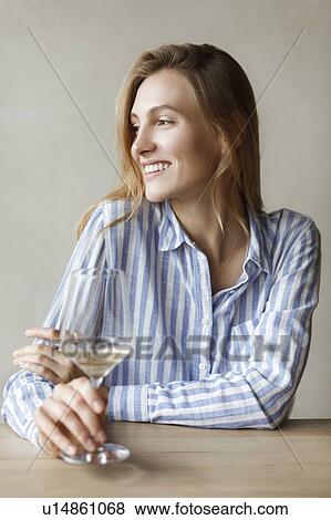 Young woman with glass of white wine View Large Photo Image Stock Photo - Young woman with glass of white wine. Fotosearch