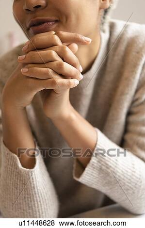 Young woman with hands clasped View Large Photo Image Stock Photo - Young woman with hands clasped. Fotosearch