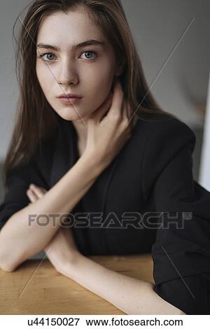 Young woman with her hand on her neck View Large Photo Image Stock Photo - Young woman with her hand on her neck. Fotosearch