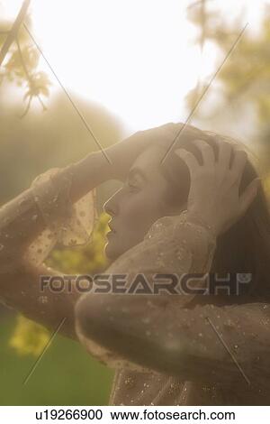 Young woman with her hands on her head View Large Photo Image Stock Image - Young woman with her hands on her head. Fotosearch