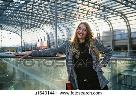 Stock Image - Young woman with long blond hair in train station, portrait, Turin, Piemonte, Italy. Fotosearch