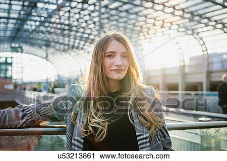 Young woman with long blond hair in sunlit train station, portrait, Turin, Piemonte, Italy View Large Photo Image Stock Image - Young woman with long blond hair in sunlit train station, portrait, Turin, Piemonte, Italy. Fotosearch
