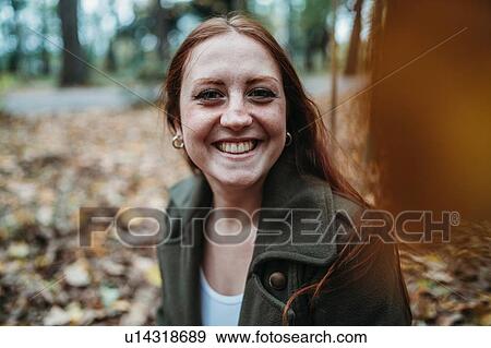 Young woman with long red hair in autumn park, portrait View Large Photo Image Stock Photo - Young woman with long red hair in autumn park, portrait. Fotosearch