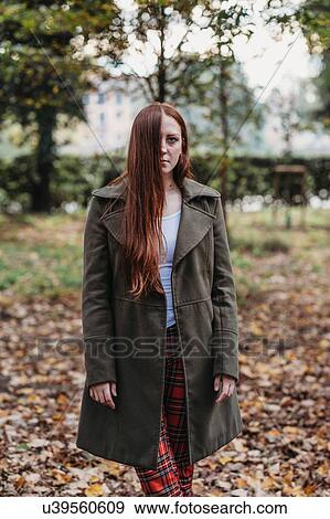 Young woman with long red hair in autumn park, portrait View Large Photo Image Stock Photo - Young woman with long red hair in autumn park, portrait. Fotosearch