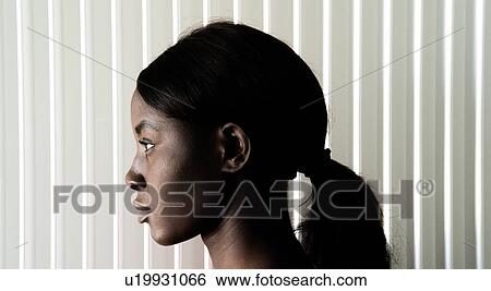 Stock Photograph - Young woman with ponytail, head profile portrait. Fotosearch