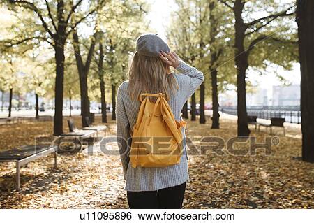 Young woman with yellow backpack in park in Berlin, Germany View Large Photo Image Stock Photograph - Young woman with yellow backpack in park in Berlin, Germany. Fotosearch