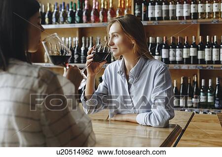 Young women drinking red wine View Large Photo Image Stock Image - Young women drinking red wine. Fotosearch
