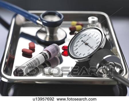 Stock Image - Assortment of medicine and equipment on a medical tray.. Fotosearch