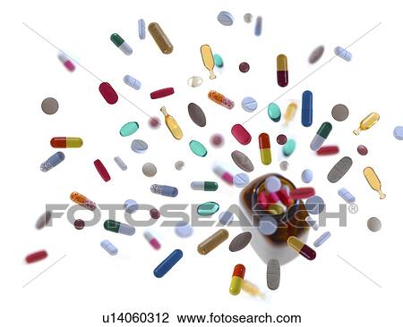 Stock Image - Assortment of pills, tablets and capsules pouring from bottle.. Fotosearch
