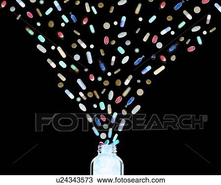Stock Image - Assortment of pills, tablets and capsules pouring from bottle.. Fotosearch