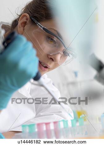 Biotechnology research. Scientist pipetting sample into a microcentrifuge tube ready for automated analysis. View Large Photo Image Stock Image - Biotechnology research. Scientist pipetting sample into a microcentrifuge tube ready for automated analysis.. Fotosearch