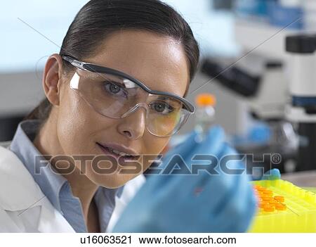 Biotechnology research. Scientist examining sample in a test tube ready for automated analysis. View Large Photo Image Stock Image - Biotechnology research. Scientist examining sample in a test tube ready for automated analysis.. Fotosearch