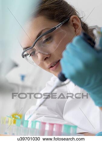 Biotechnology research. Scientist pipetting sample into a microcentrifuge tube ready for automated analysis. View Large Photo Image Stock Image - Biotechnology research. Scientist pipetting sample into a microcentrifuge tube ready for automated analysis.. Fotosearch
