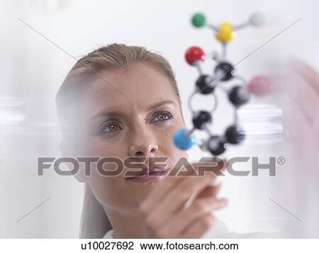 Chemistry research, conceptual image. Scientist using a molecular model to understand a chemical formula. View Large Photo Image Stock Image - Chemistry research, conceptual image. Scientist using a molecular model to understand a chemical formula.. Fotosearch