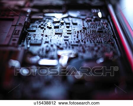 Stock Image - Computer hardware. Interior of a laptop computer showing chips, circuit boards and components.. Fotosearch