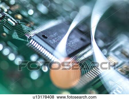 Stock Photo - Digital communication, conceptual image. Fibre optics carrying data over electronic circuitry on a laptop computer.. Fotosearch